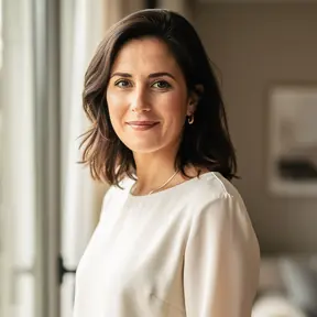 Portrait of a French woman in her early 40s, soft natural lighting, warm neutral tones, lifestyle photography, calm and professional expression, shallow depth of field, high resolution
